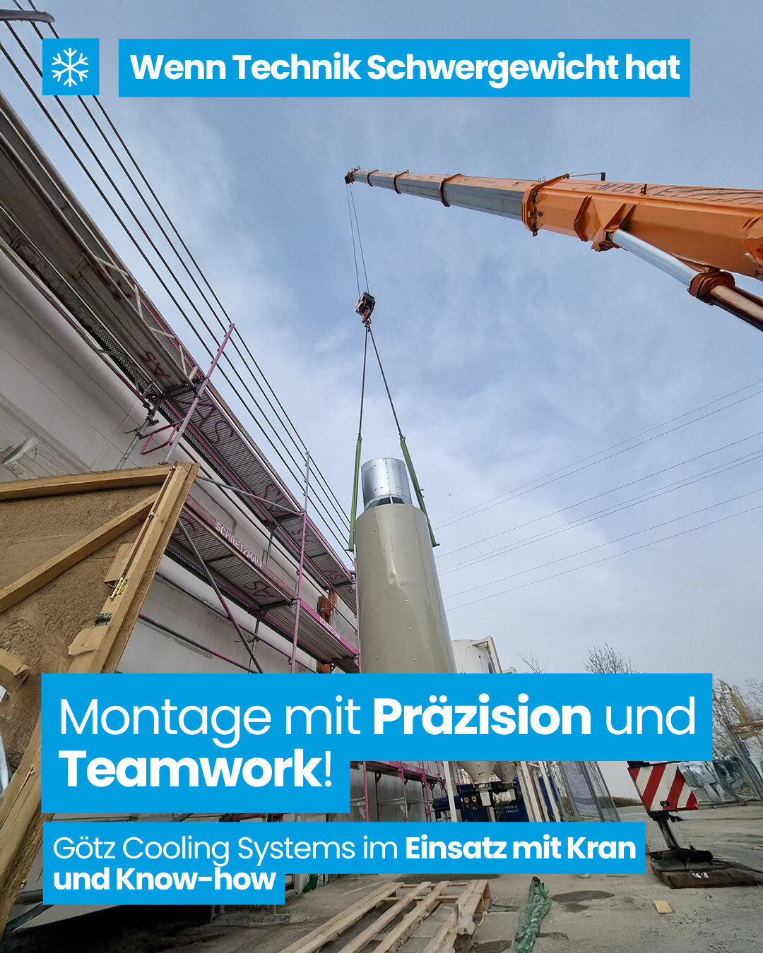 Industriebauteil wird mit einem Kran an einer Gebäudefassade montiert. Montageeinsatz von Götz Cooling Systems auf einer Baustelle.